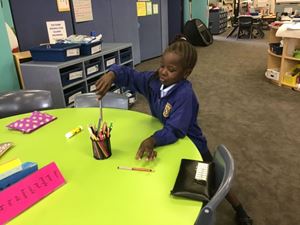 Putting pencils back in the tins
