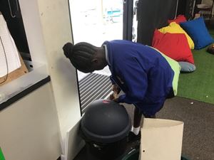 Putting rubbish in the bin in the classroom