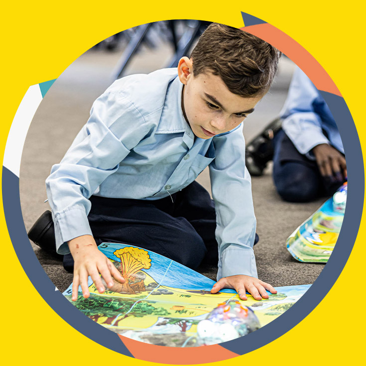 St Bernadette's Catholic Primary School Lalor Park student learning on rug
