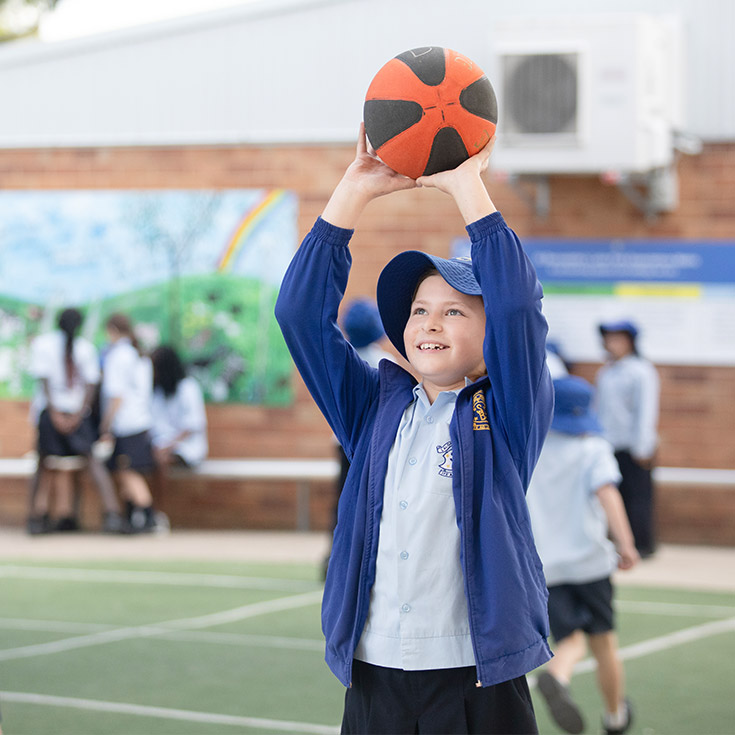 St Bernadette's Catholic Primary School Lalor Park boy playing basketball